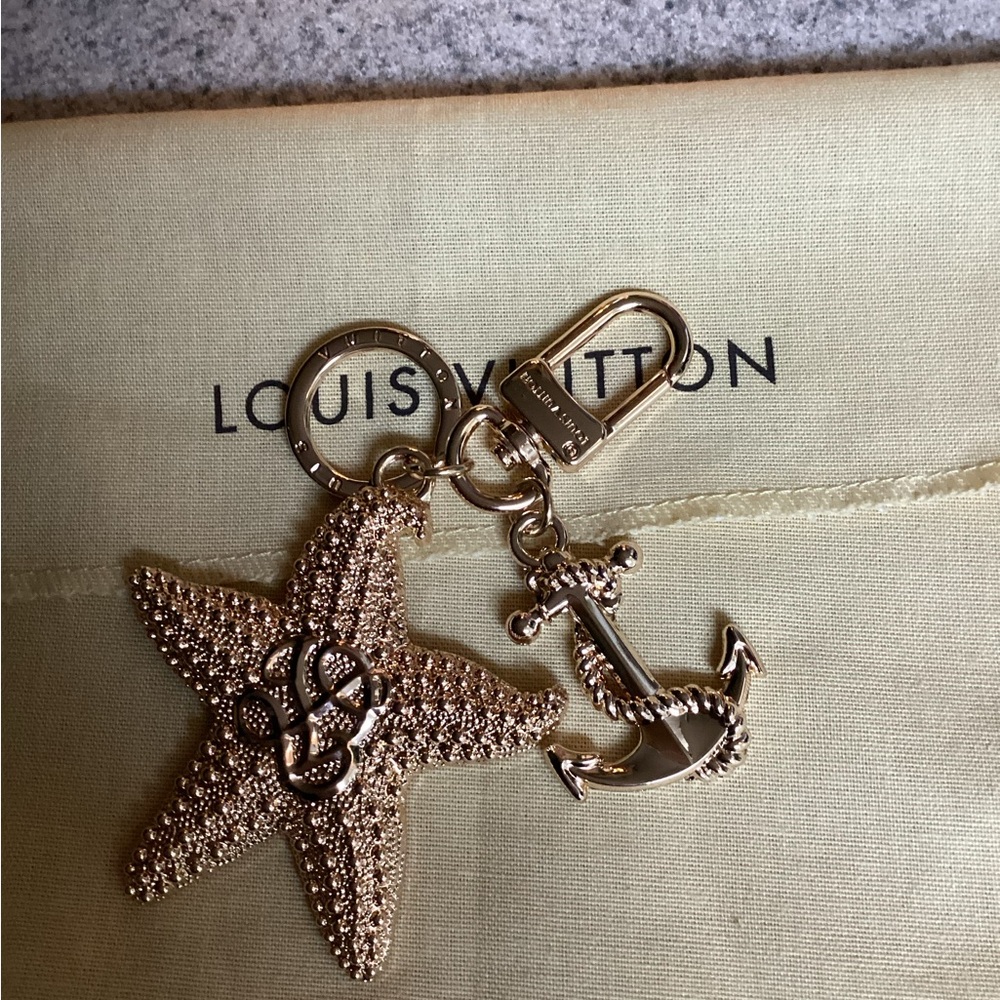 LV gold starfish and anchor bag charm.